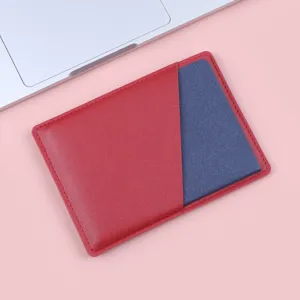 Ultra-thin red leather passport and card holder for men and women on pink background