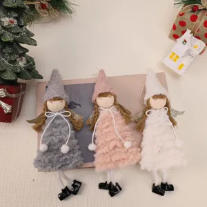 Close-up of three plush Christmas angel girl hanging ornaments in grey, pink, and white