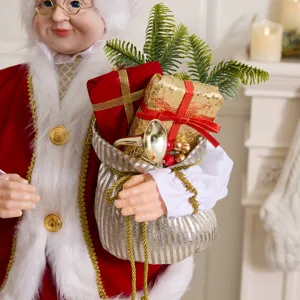 Statuetta della Signora Claus con sacco regalo e scatole di paillettes dorate casa