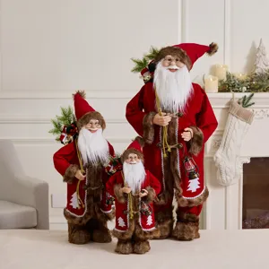 Three standing Santa Claus figurines with lanterns in various sizes for Xmas decor.