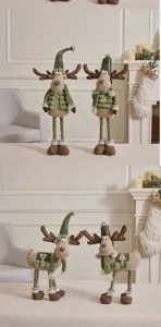 Detailed view of two styles of green and brown plush reindeer Christmas decorations standing on a table.