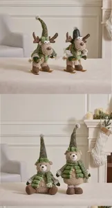 Detailed macro view of alfalfa green plush Christmas reindeer and bear dolls for festive decor