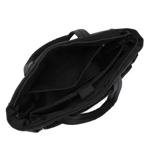 Detailed view of the interior compartments and laptop sleeve of a black quilted tote bag