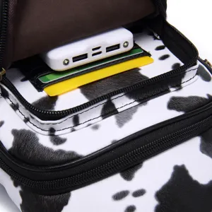 Close-up of interior card slots in cow print small crossbody chest bag