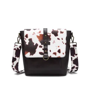 Detailed view of western style cow print crossbody bag with vintage leather texture flap