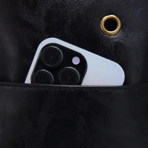 Close-up detail of retro black textured leather crossbody bag with a handy outer pocket
