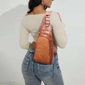 Close-up view of vintage floral embossed brown sling bag worn as a stylish chest pack