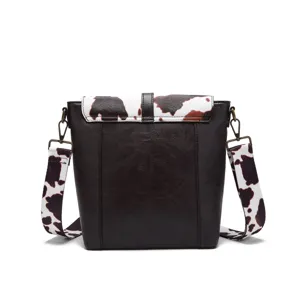 Detailed back view of vintage cow print crossbody bag with premium brown textured leather