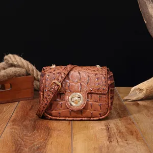 Vista detallada de un bolso vintage marrón con textura de cocodrilo