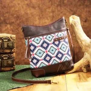 Detailed view of bohemian Aztec print crossbody bag with vintage leather trim