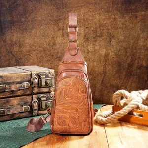 Detail of vintage embossed brown leather chest bag with Bohemian floral patterns