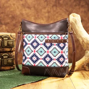 Detailed view of bohemian Aztec print crossbody bag with tassel and stud accents