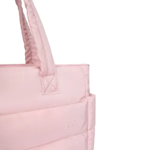Close-up of pink quilted travel bag showing handle stitching and puffy nylon texture.