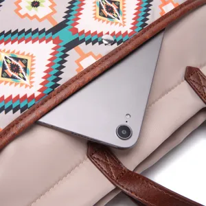 Detailed macro view of internal pocket in Aztec pattern tote bag with tablet stored