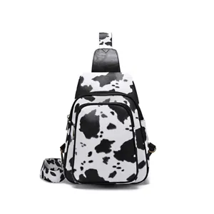 Vintage cow print sling bag for women featuring front zipper pocket and wide strap