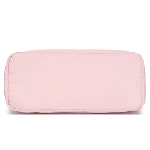 Macro view showing the reinforced base stitching of the pink quilted lightweight travel bag