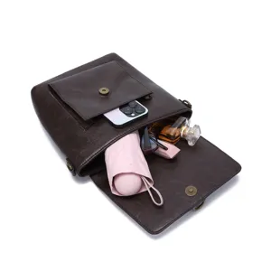 Vintage brown leather crossbody bag showing inner capacity with daily essentials