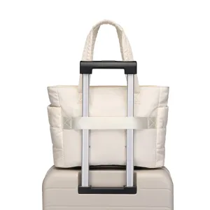 Detailed view of lightweight quilted travel bag with trolley sleeve mounted on a suitcase handle