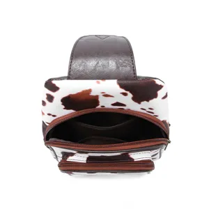 Detailed internal view showing organized zipper pocket of vintage cow print chest bag