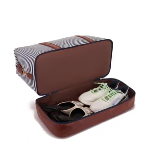 Bolsa de viaje grande a rayas con detalles en cuero y espacio para los zapatos