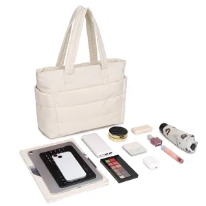 Quilted cream tote bag shown with daily essentials like laptop and makeup to illustrate capacity.