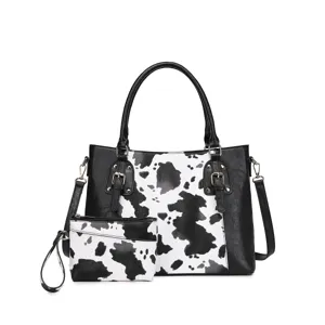 Vista detallada del bolso vintage con estampado de vaca y herrajes dorados chic