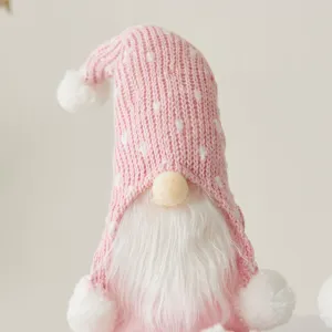 Handcrafted Nordic Christmas gnome featuring a pink polka dot knitted hat and white beard