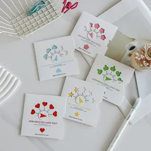 Close-up of creative rotating greeting cards with heart and star hollow designs.