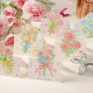 Primo piano di eleganti biglietti d'auguri pop-up floreali con mazzi di fiori disegnati