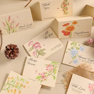 Multiple vintage kraft greeting cards with elegant floral watercolor illustrations.