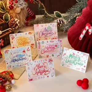 Detailed shot of various cartoon Christmas greeting cards with hand-written text