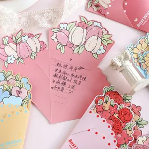 Detail view of colorful bouquet-shaped greeting cards with floral patterns and handwritten note.