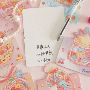 Detailed view of colorful cartoon candy themed greeting cards with handwritten message