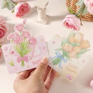 Dettaglio di biglietti d'auguri floreali con motivi Happiness e Sweet Dreams.