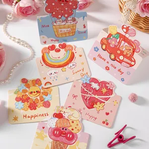 Close-up of colorful cartoon greeting cards featuring cute illustrations and blessing quotes