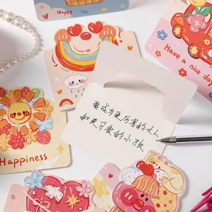 Close-up view of cute cartoon graffiti greeting cards with a handwritten message.