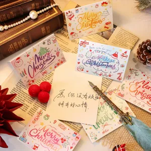 Cozy assortment of festive Christmas cards with 'Merry Christmas' cartoon designs and a pen.