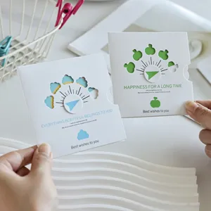 Detailed view of creative rotating hollow blessing greeting cards held in hands