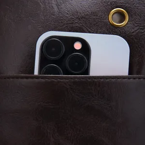 Close-up detail of the storage pocket on a brown vintage faux leather crossbody bag