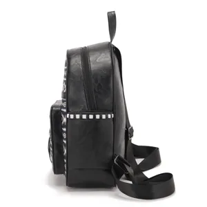Detailed side view of black faux leather backpack featuring Aztec Bohemian pattern print