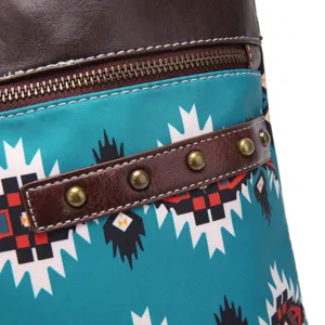 Detailed macro view of bohemian Aztec print crossbody bag with brass rivets detail