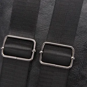 Close-up detail of durable black nylon adjustable straps and metal buckles on backpack.