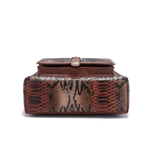 Detailed view of the structured bottom of a vintage brown snakeskin pattern tote bag.