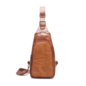 Detailed view of vintage brown chest bag with intricate floral embossing and western style