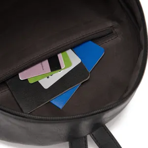 Close-up of the interior zipper pocket in a black bohemian style backpack with cards