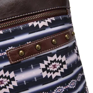 Detail view of Aztec print waterproof fabric and leather studs on a vintage crossbody bag