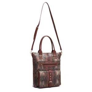 Detailed view of brown snakeskin tote bag with Aztec pattern accents and front pocket