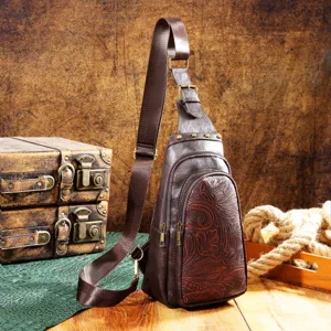 Detailed view of a vintage brown leather sling bag with western floral embossing
