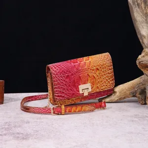 Vista detallada del bolso bandolera vintage con patrón de cocodrilo fucsia degradado