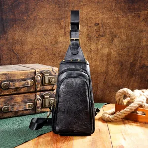 Vintage black embossed Bohemian sling bag with floral patterns and rustic background